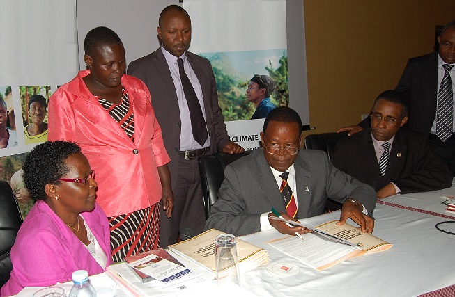 The Minister signing the Strategy.