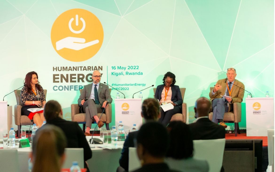 Moderator and high-level panellists in discussion; from left Anila Noor, Global Refugee-led Network (GRN), Mark Carrato, Power Africa USAID, Veneranda Ingaband, Government of Rwanda, and Andrew Harper, UNHCR