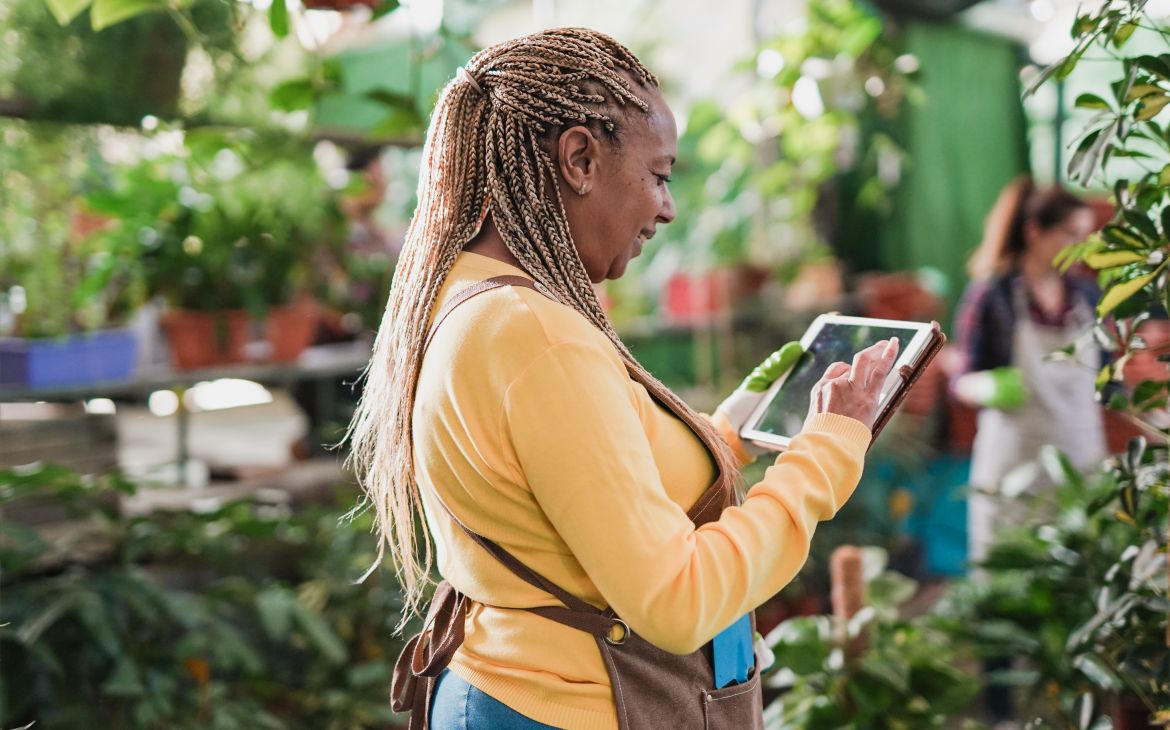 Entrepreneurship, Innovation and Leadership Training for Women Entrepreneurs in Africa (Photo by Sabrina Bracher, Envato Elements) African woman using digital tablet while working in a greenhouse