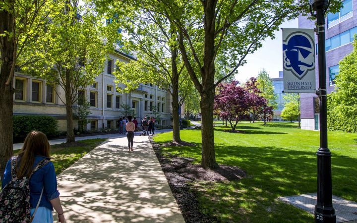 People walk through Seton Hall University's beautiful campus.