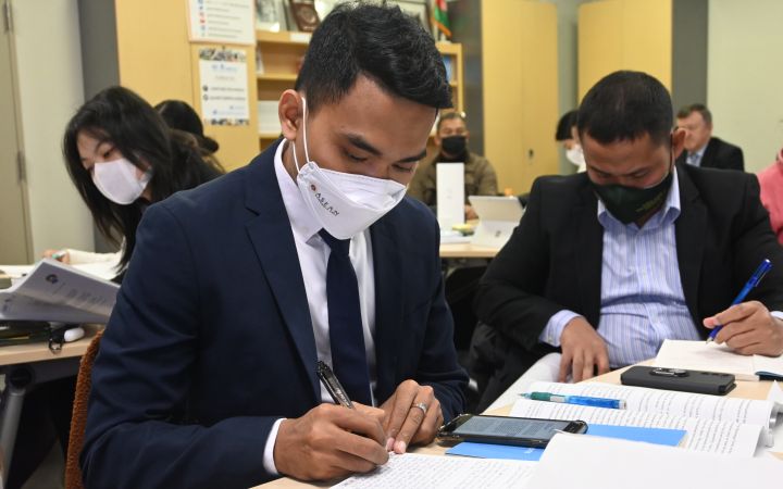 Diplomats from the Nuclear Disarmament and Non-Proliferation Training Programme are writing down notes in preparation of the negotiation simulation
