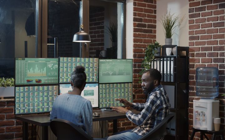 Introduction to Capital Market Development (Photo via Envato Elements) Colleagues having a discussion in front of the charts on their screens
