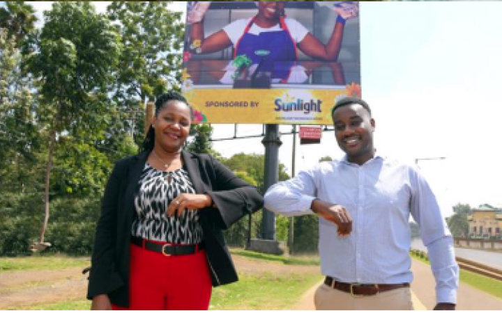 Unilever East Africa’s Home Care Director Henry Muchauraya and Absa’s Director of Business Banking Elizabeth Wasunna Unilever East Africa’s Home Care Director Henry Muchauraya and Absa’s Director of Business Banking Elizabeth Wasunna touching elbows in front of the Sunlight billboard