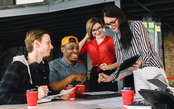 Youth Entrepreneurship: Leadership Skills (Photo via Envato Elements) Young colleagues smiling while their attention are direction to the tablet