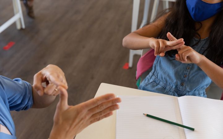 Student and teacher using sign language (Envato Elements) Student and teacher using sign language