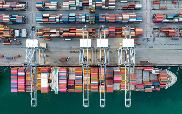 Aerial view of cargo ship and containers at a port (Photo via Envato Elements) 