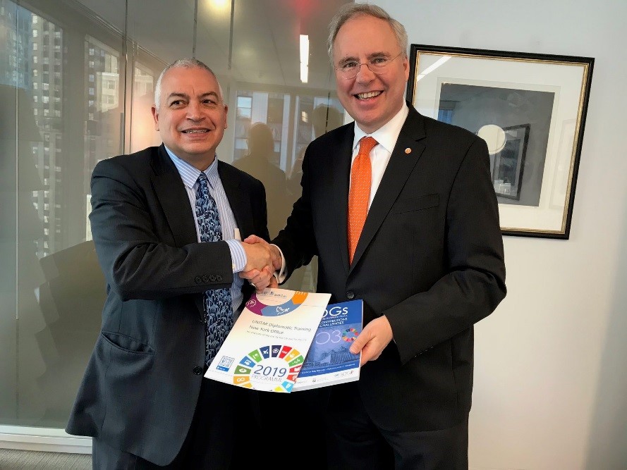 Head of Office UNITAR NYO, Mr. Marco Suazo handing 2019 UNITAR Catalogue and recent publication to H.E. Mr. Karel Jan Gustaaf van Oosterom, Permanent Representative of Netherlands to the UN. Photo credit: UNITAR NYO